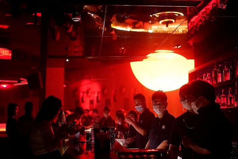 People with face masks at a nightclub after it reopened in Shanghai, China, last Friday. PHOTO: REUTERS