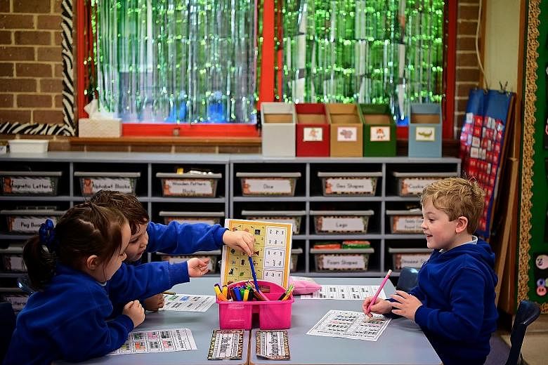 Kindergarten pupils working on an activity at Annandale Public School in Sydney, Australia, yesterday. Children returned to full-time face-to-face learning in New South Wales and this allowed many parents to return to offices.