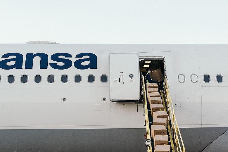 Above: Cargo being loaded onto a Lufthansa flight at Frankfurt Airport in Germany last month. Left: To make up for lost revenue, Lufthansa is hauling more cargo onto planes, including where passengers used to sit.
