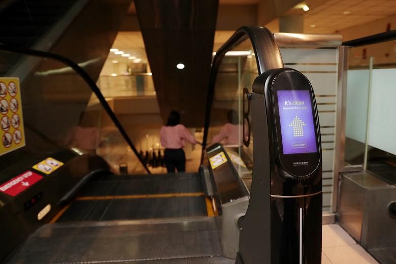 WeClean, an automated escalator handrail cleaning device, was installed at KK Women's and Children's Hospital last Friday. The device was installed at one escalator and will remain for a month to assess its effectiveness. ST PHOTO: GIN TAY