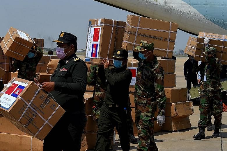 Cambodian soldiers carrying aid from China, including medical equipment to combat the spread of Covid-19 in the South-east Asian nation, last month. Beijing has sent planeloads of medical equipment abroad, pledged $2.8 billion in international aid to
