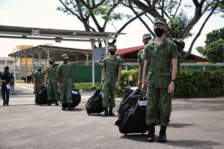 Singapore Armed Forces recruits observing safe distancing yesterday as they headed for buses taking them to the SAF Ferry Terminal. ST PHOTO: KEVIN LIM