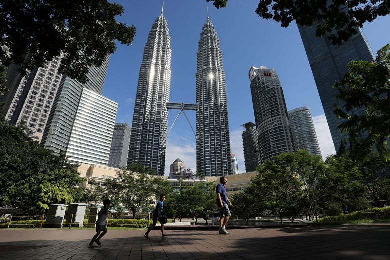 Wealthy Chinese investors are flocking to park their money in top-end property at home and overseas, including Kuala Lumpur (above) and Singapore, real estate agents say.