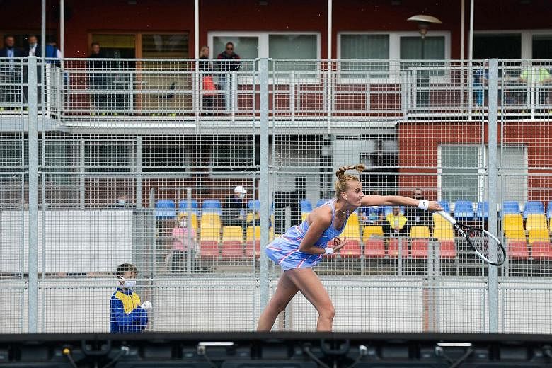 Petra Kvitova returning a shot to Barbora Krejcikova in an all-Czech exhibition match at the Sparta Prague tennis club. They were playing to raise funds for those affected by the coronavirus pandemic in the Czech Republic.