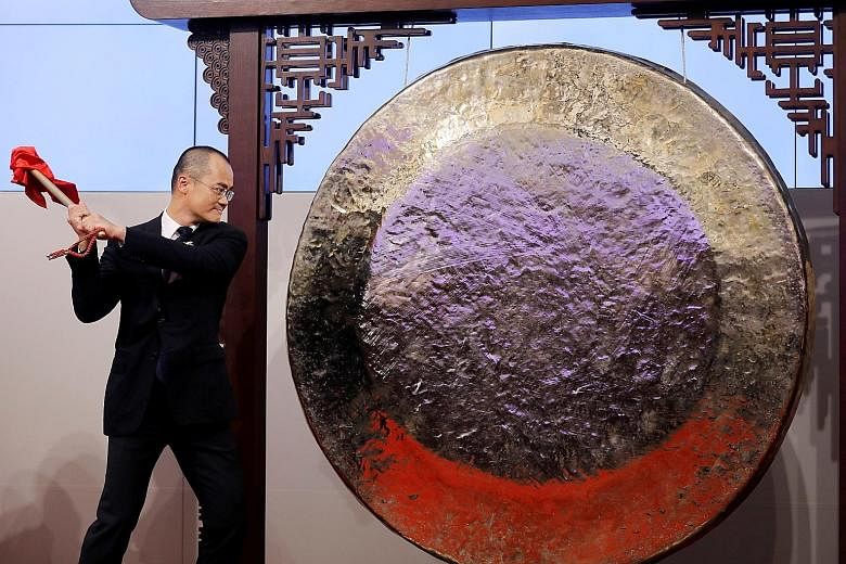 Mr Wang Xing, founder and CEO of Meituan Dianping, striking a gong during the company's debut in Hong Kong in September 2018. Meituan's stock rose 10.4 per cent on Tuesday after it reported better-than-expected revenue, driving its market value past 