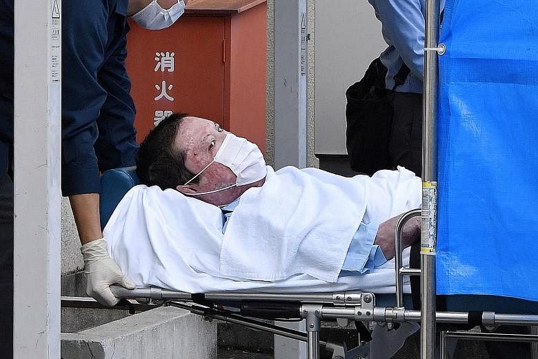 Suspect Shinji Aoba being taken to a police station in Kyoto yesterday, following his formal arrest over a fire that killed 36 people in the Japanese city last year. He could not be questioned earlier because he had suffered serious burns in the blaz
