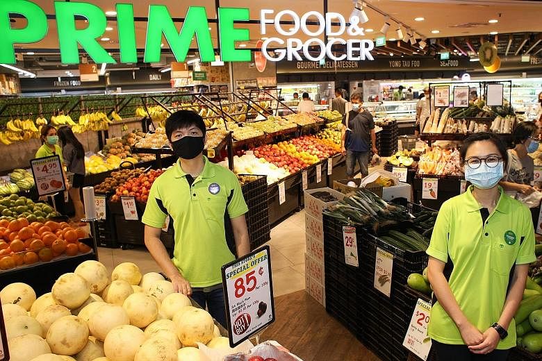 (From left) Retail assistants Niki Lim and Wendy Leong are working at Prime Food & Grocer supermarket in Century Square mall. Ms Leong, an air stewardess who was placed on furlough, applied through the virtual career fairs platform under Workforce Si