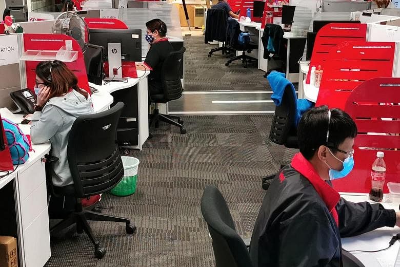 Customer care officers at Singtel. The telco is looking to fill around 2,000 jobs to meet needs in areas such as 5G, cloud and the Internet of Things.