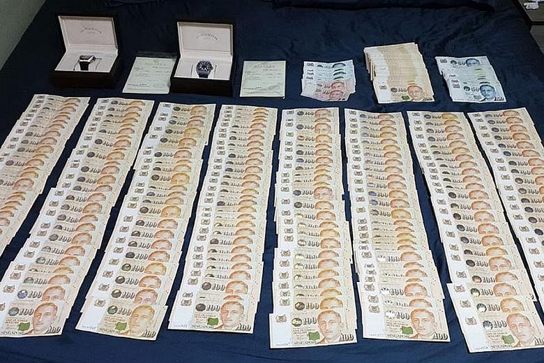 Two watches and more than $81,000 in cash were seized from Chee Jian Rong's home. He allegedly duped a foreign distribution firm.