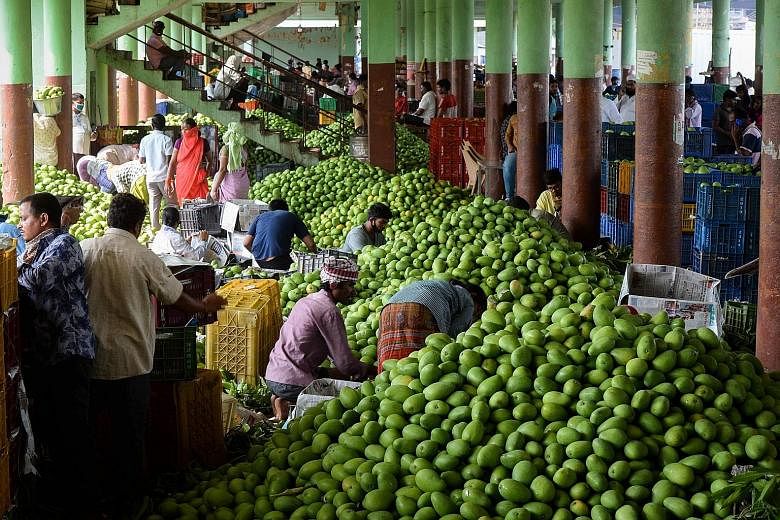 Workers packing mangoes at a market in India. The government hopes reforms in the farm sector will boost the overall economy. PHOTO: AGENCE FRANCE-PRESSE