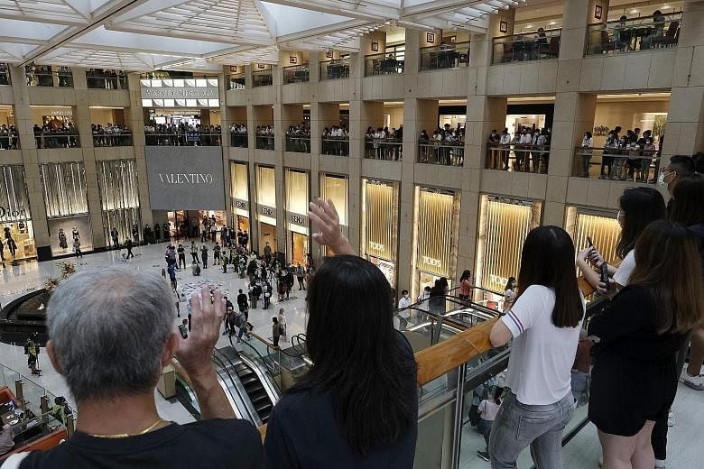 A lunchtime protest against China's new national security law at a mall in Hong Kong yesterday. US President Donald Trump is apparently considering a temporary suspension of Hong Kong's special status as a separate Customs territory under the US-Hong