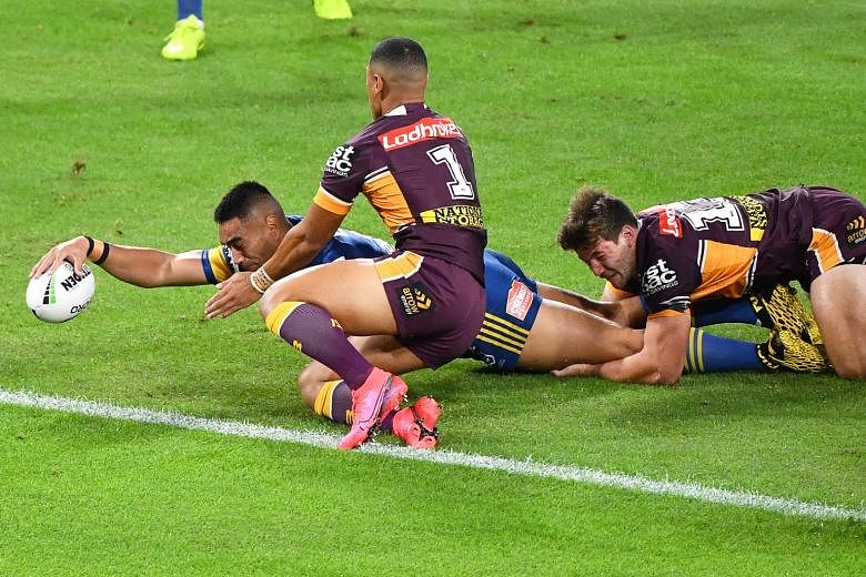 Marata Niukore of the Parramatta Eels scoring a try during their 34-6 victory over hosts Brisbane Broncos in the National Rugby League (NRL) yesterday. The NRL, played behind closed doors, is one of the world's first contact sports to resume after Co