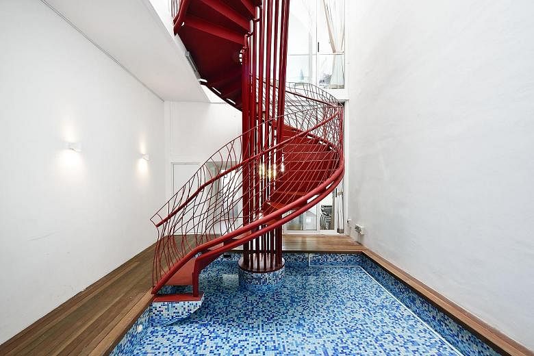 Figment's No. 13, also called the Red Dragon house, is part of the developer's Lorong 24A Shophouse Series. HYLA architects imagined a red dragon-esque steel spiral staircase rising from the ground level pool to the ceiling. 
