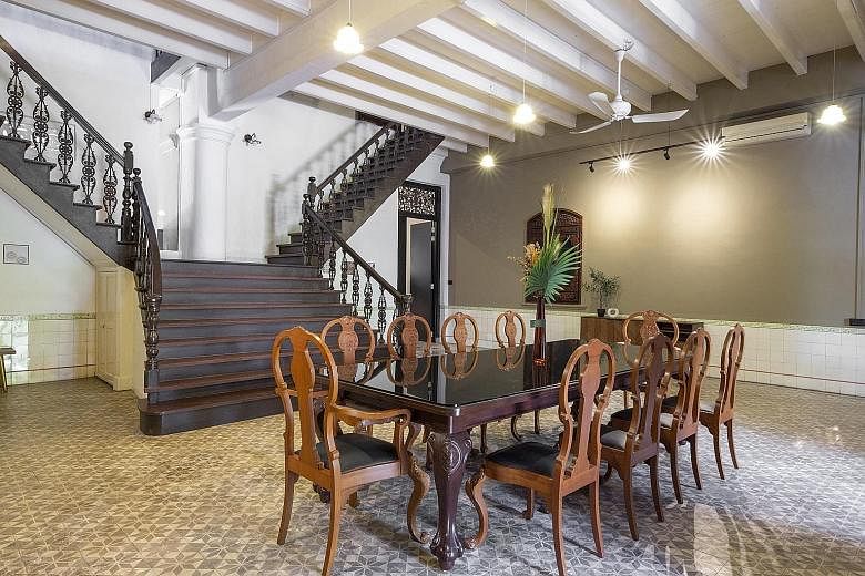 Dining lounge at Emerald Hill in clear view of the grand staircase. The interior and accents reflect the neighbourhood's distinctive Peranakan history. 