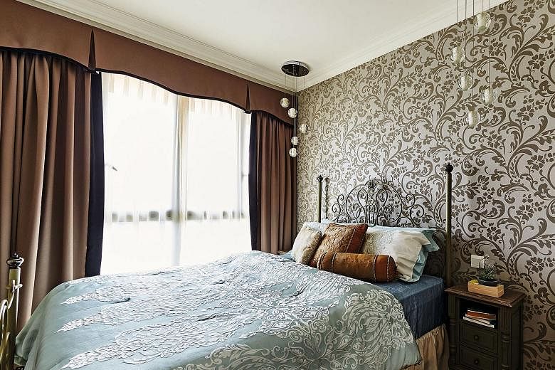 Wallpaper enhances the intimate ambience of the master bedroom. 
