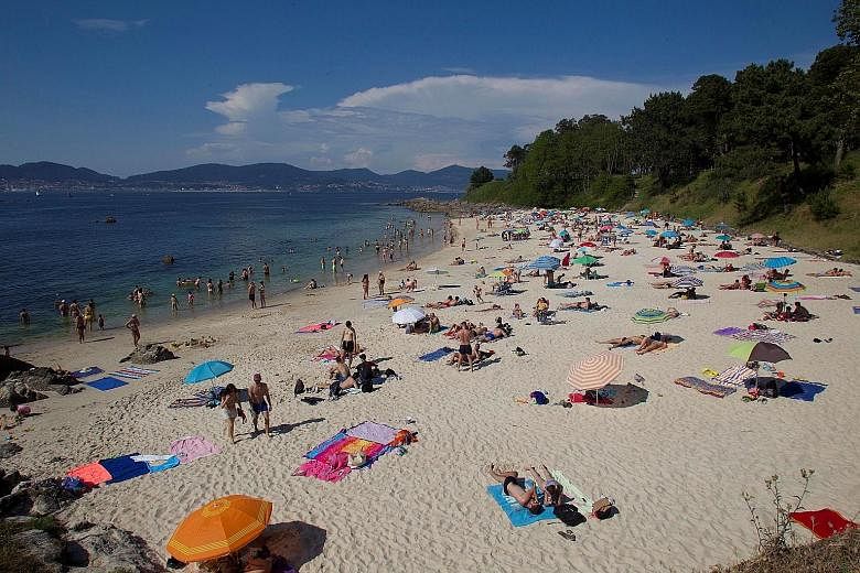 People at La Fuente beach, in Vigo, Spain, on Thursday, after the country eased Covid-19 lockdown curbs. Infectious diseases expert Bruce Aylward has been struck by the "astonishing speed" with which the coronavirus overwhelmed sophisticated Western 