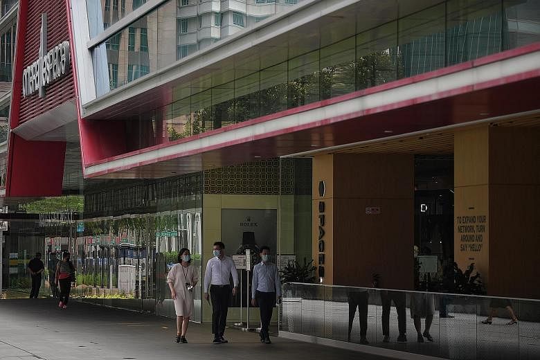 People during lunch time at Raffles Place in an almost empty Central Business District on Wednesday. Businesses which do not ensure that employees work from home where possible, or whose workers do not adhere to safe management measures, may have to 