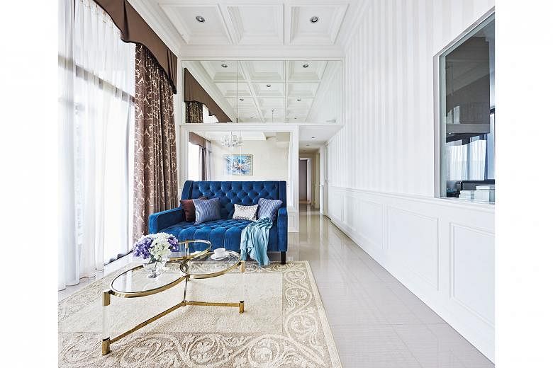 The coffered ceiling illustrates the loftiness of the room, while the armchairs are perfect for a tete a tete.