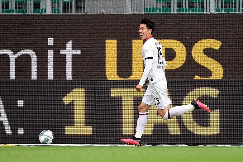 Eintracht Frankfurt's Daichi Kamada celebrating after scoring the winner in his side's 2-1 Bundesliga victory at Wolfsburg yesterday. The Japanese midfielder fired home to clinch all three points following a cross in the 85th minute. The result left 