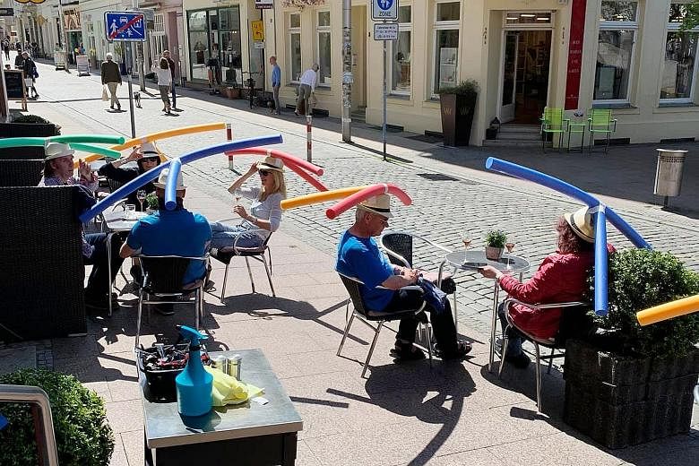 To celebrate the easing of the country’s coronavirus lockdown, Cafe Rothe (above) in Schwerin, Germany, handed out pool noodle hats to patrons as a social-distancing enforcement gimmick. 