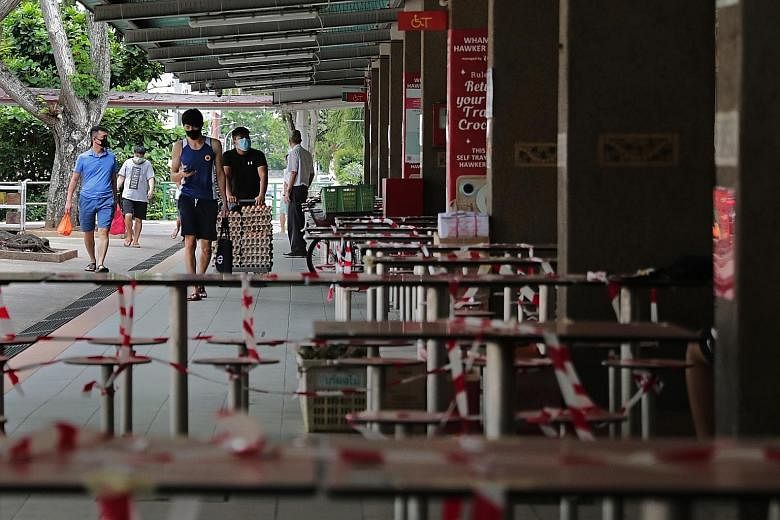 Taped-up tables and chairs at Whampoa Hawker Centre on Thursday, to stop people from dining in. In the first phase of reopening Singapore's economy, schools will gradually restart, and more Singaporeans will return to workplaces, though dining in wil