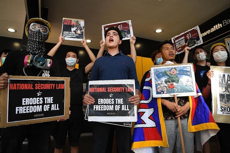 Protesters rallying against Beijing's new national security law for Hong Kong outside the Chinese consulate in Brisbane, Australia, yesterday. The legislation paves the way for China to enact a controversial anti-sedition law in Hong Kong aimed at su