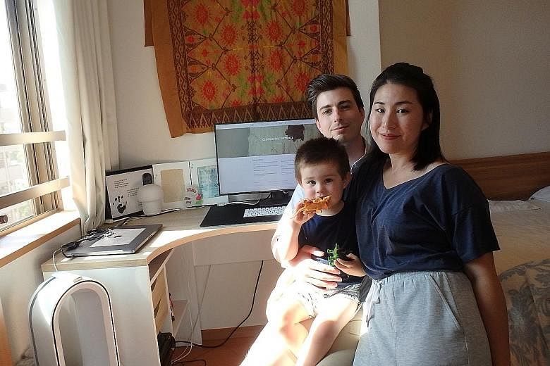 Norwegian John Edvard, seen here with his Japanese wife and their son at his workspace in their Fukuoka home, says flexiwork has enabled him to "work in batches".