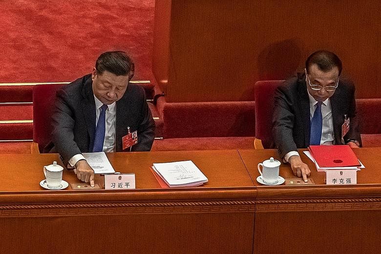 Chinese President Xi Jinping (left) and Premier Li Keqiang voting on the resolution for a national security law in Hong Kong at the National People's Congress in Beijing on Thursday. The resolution was passed that day. PHOTO: EPA-EFE