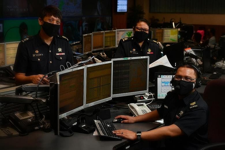 From left: Warrant Officer Derrick Neo, WO Hazlina Ja'afar and Sergeant Muhammad Aminurashid Ya'acob at the Singapore Civil Defence Force Operations Centre. Operators try to identify suspect Covid-19 cases by asking basic triage questions, which chan
