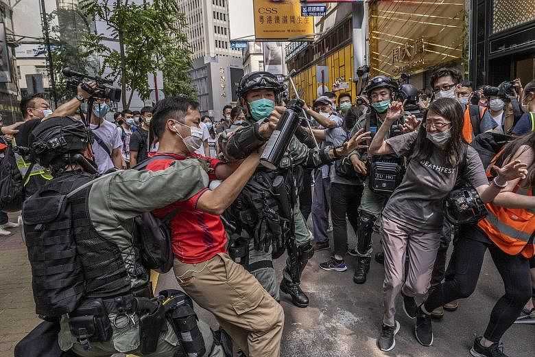 Protesters clashing with riot police officers in Hong Kong last Wednesday. The city is bracing itself for more demonstrations in the coming weeks against Beijing's planned national security legislation for Hong Kong, and the United States has said it