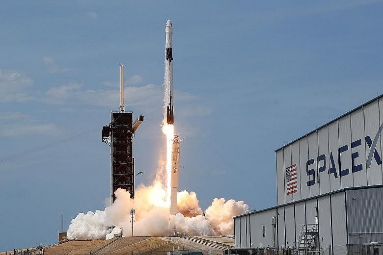 The SpaceX Falcon 9 rocket lifting off from the Kennedy Space Centre in Cape Canaveral, Florida, yesterday, with Nasa astronauts Doug Hurley and Bob Behnken on board. The 19-hour ride in the Crew Dragon capsule will take them to the International Spa