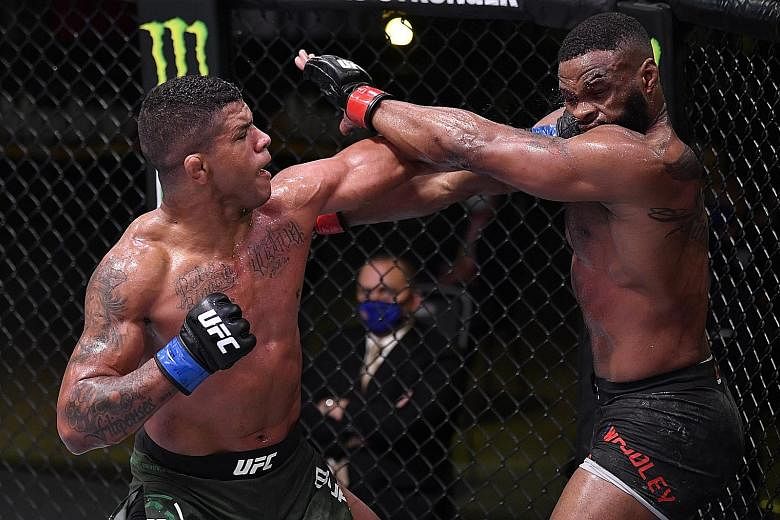 Gilbert Burns (left) punching Tyron Woodley in their welterweight bout during UFC Fight Night. Burns said he made a statement after defeating the former champion and has his sights on Kamaru Usman's belt. 