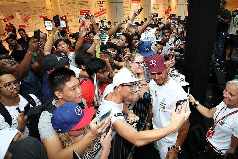 Fans clamouring for wefies in 2018 with Mercedes driver Lewis Hamilton, who won his fourth Singapore night race that year. 