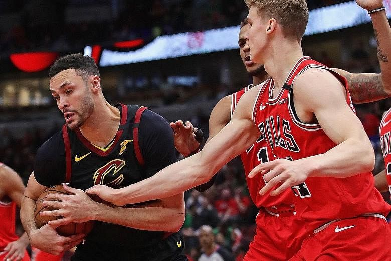 Cleveland's Larry Nance Jr trying to keep the ball away from Lauri Markkanen of the Chicago Bulls at the United Centre on March 10, a day before the NBA suspended its season. The Cavaliers forward, 27, is "scared" of making an NBA comeback during the coro