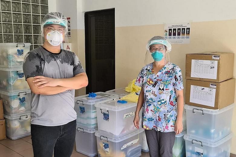 Volunteer "swabber" Elmer Chan (left), who graduated last month with a diploma in aviation management and services, with Dr Lim Lii, who carries out swab tests and trains would-be "swabbers".