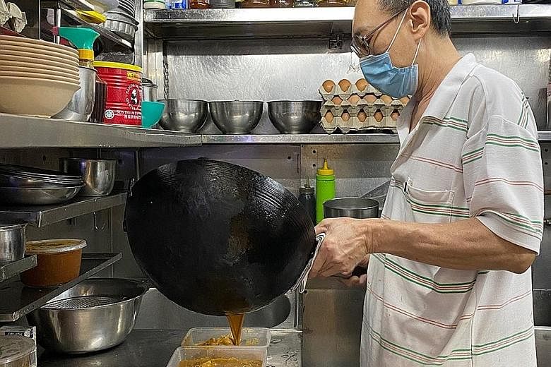 Mr Yeo See Hock, who runs Meng Kee Seafood stall at Pasir Panjang Food Centre, ladling out dishes for delivery orders. Mr Yeo said that because he has to keep prices low, the profit margins are also low. He could not afford the 30 per cent commission