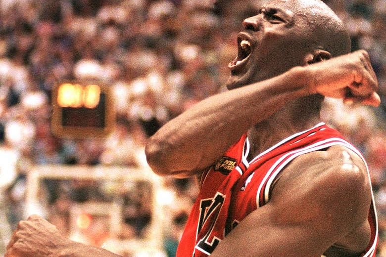 Michael Jordan of the Chicago Bulls celebrating after winning Game Six of the 1998 NBA Finals against the Jazz at the Delta Centre in Utah. He sank the winning jumper to give the Bulls a 87-86 victory and their sixth NBA title. 