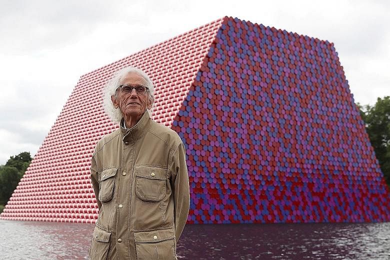 Artist Christo with his artwork Mastaba (left) built on The Serpentine lake in London, in 2018. His grand projects included wrapping the Reichstag in Berlin (above), in 1995.