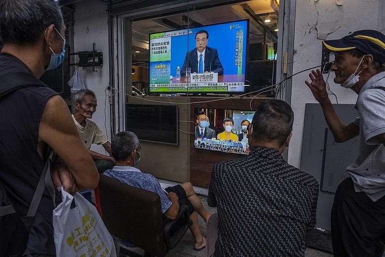 Hong Kongers watching a TV news show about Beijing's new national security legislation for the city last week, which prompted the US to say it would end its special relationship with the territory. PHOTO: NYTIMES
