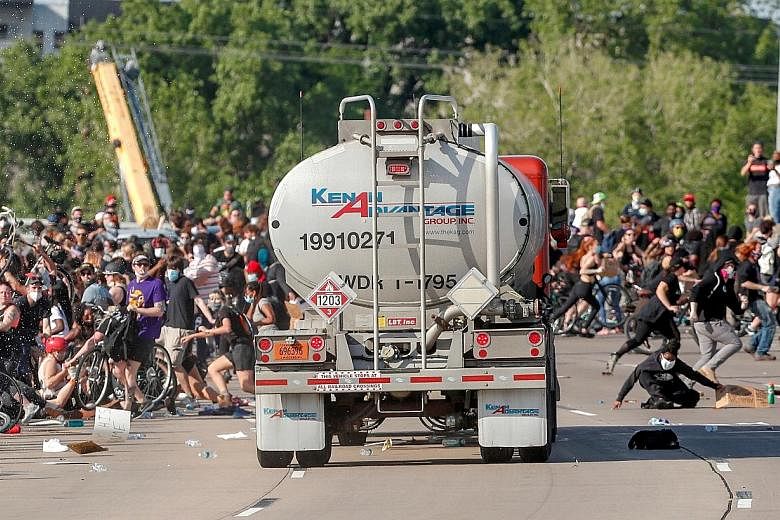 A truck being driven at high speed into a crowd of protesters marching on the 35W northbound highway in Minneapolis, Minnesota, on Sunday during a protest over the death of a black man, Mr George Floyd, while in police custody. According to media rep