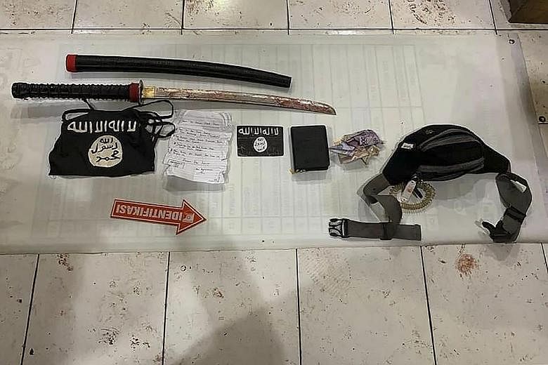 The belongings of one of the attackers in yesterday's raid at a police post in South Daha district in South Kalimantan on Indonesia's Borneo island.