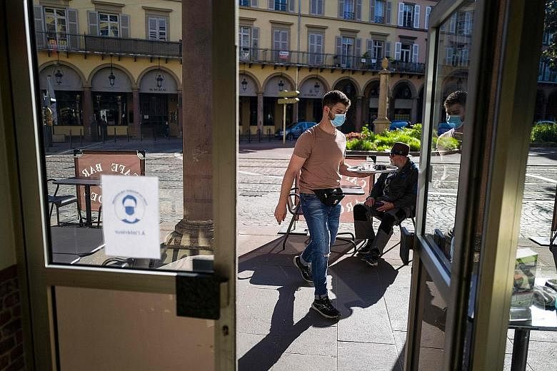 A cafe in Mulhouse, eastern France, open for business yesterday. Across the country, public gatherings of more than 10 people are still banned until June 21.