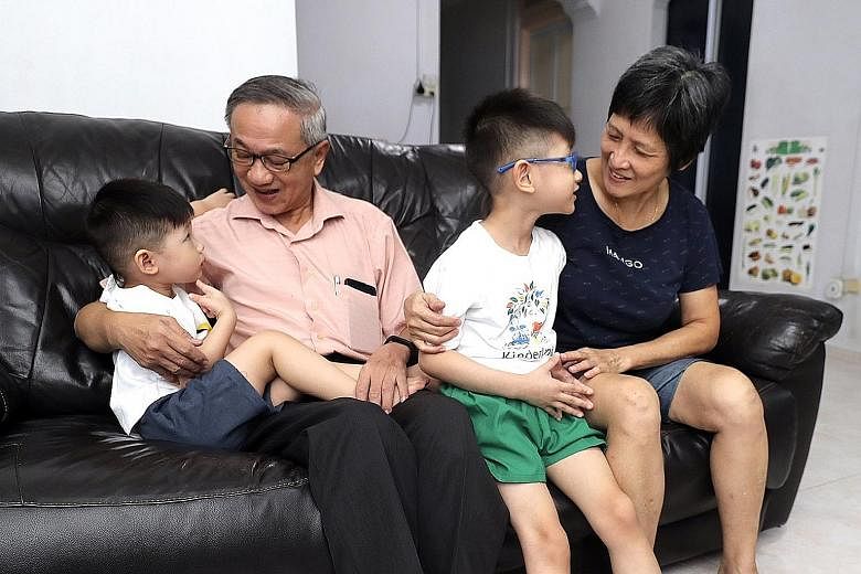 Mr Yeo Khee Soon and Madam Lee Siam Hiang with grandsons Yeo Yew Kia, five, and Yeo Yew Kye, two, yesterday. The couple were delighted at being able to see and hug their grandsons for the first time in two months.