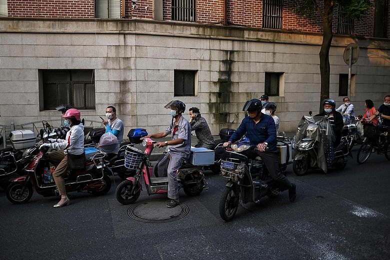 Riders out and about on scooters in Shanghai, which saw one new imported case of Covid-19 on Monday. The other four new imported infections were reported in the provinces of Sichuan, Guangdong and Shaanxi.