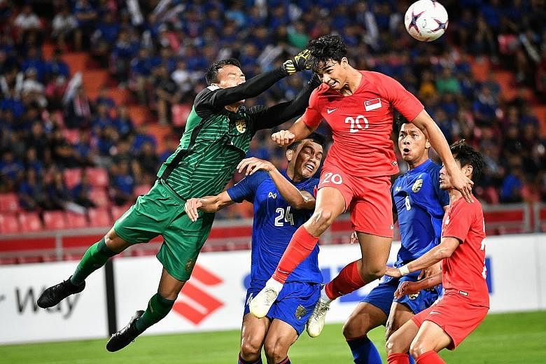Thailand goalkeeper Chatchai Budprom thwarting Ikhsan Fandi's attempt at goal in a group game at the last AFF Suzuki Cup in Bangkok. Singapore lost 3-0.