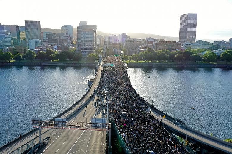 Protesters crossing Morrison Bridge in Portland, United States, on Wednesday, while rallying against the death of Mr George Floyd. PHOTO: REUTERS