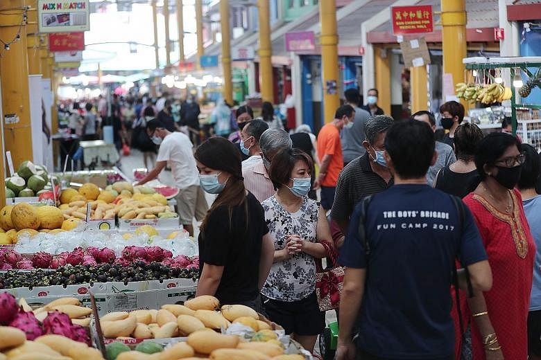 People at a market in Bukit Panjang Ring Road on Tuesday. With the June payout, the total sum given out to Singaporeans, under the Care and Support Package and the Solidarity Payment this year, reaches $3.5 billion.