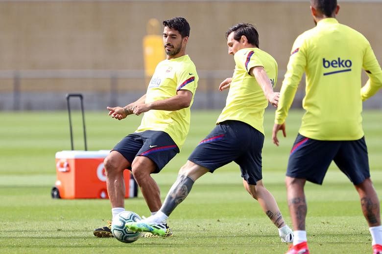 Barcelona's strikers Luis Suarez (far left) and Lionel Messi at training last week. Former Barca winger Luis Garcia says the Argentinian star is showing much intensity, while the Uruguayan has recovered from injury.