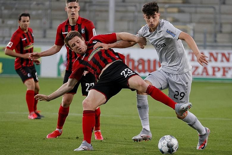 Leverkusen's 20-year-old forward Kai Havertz (in white) vying for the ball with Freiburg's Dominique Heintz during their Bundesliga match last month. The youngster will be looking to add to his 15-goal total this season against Bayern Munich today.