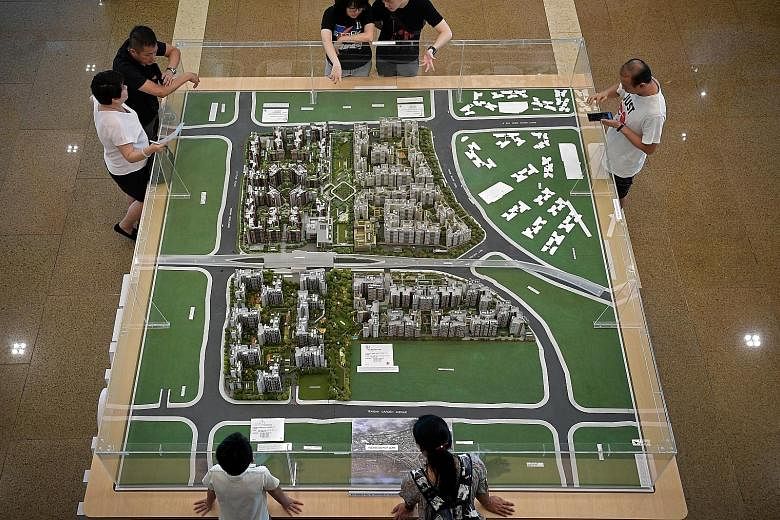 Potential home buyers viewing a model of Housing Board flats at the HDB's Toa Payoh office. Mr Paul Wee of PropertyGuru Group says the lowered interest rates on Sibor-pegged loans could help home owners alleviate what could be their biggest recurring